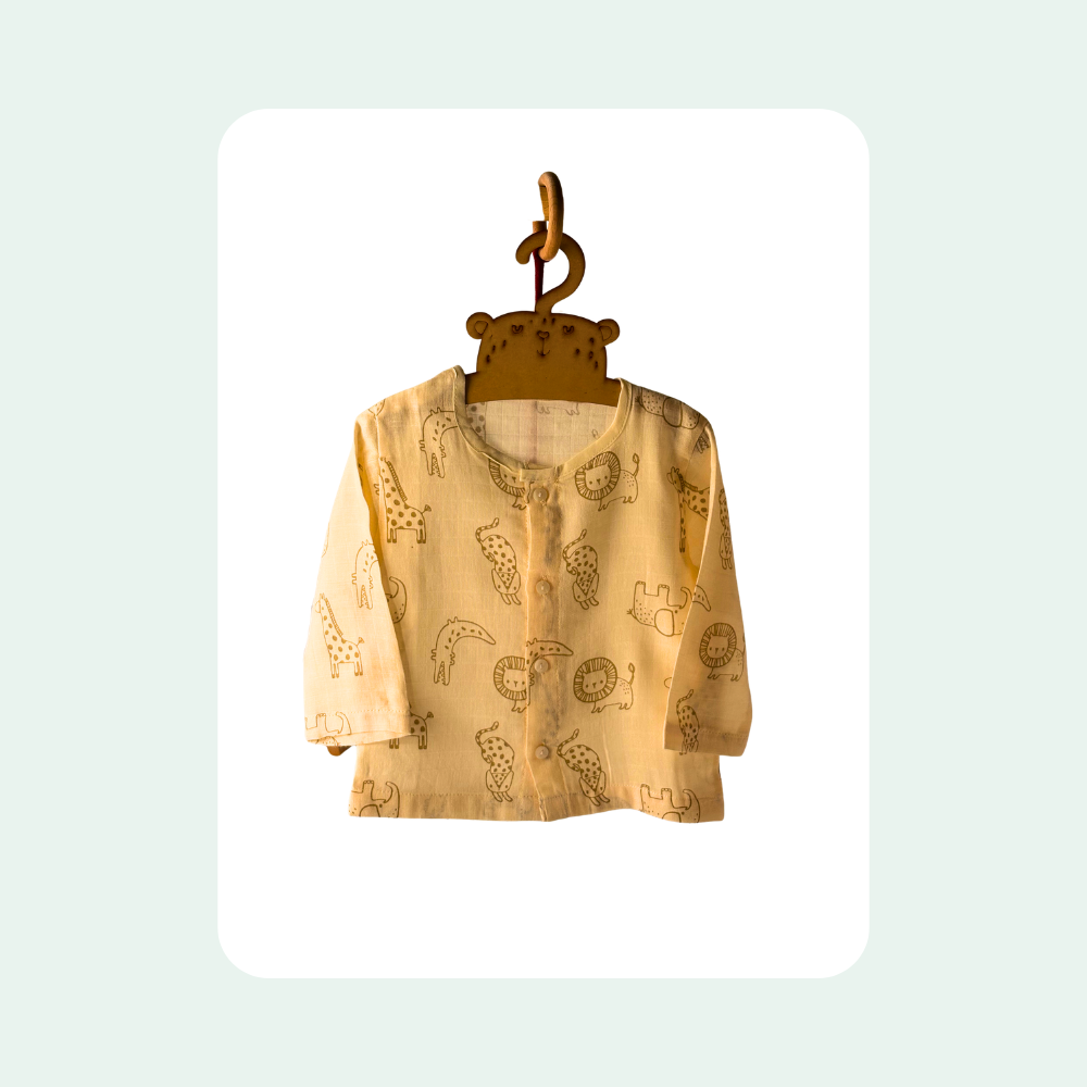 “Soft organic muslin baby top with button front and animal print in neutral beige”