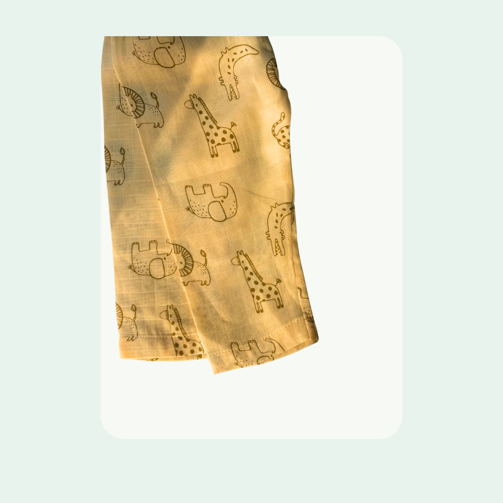 “Lightweight muslin baby pants with cute animal print, breathable organic fabric detail”